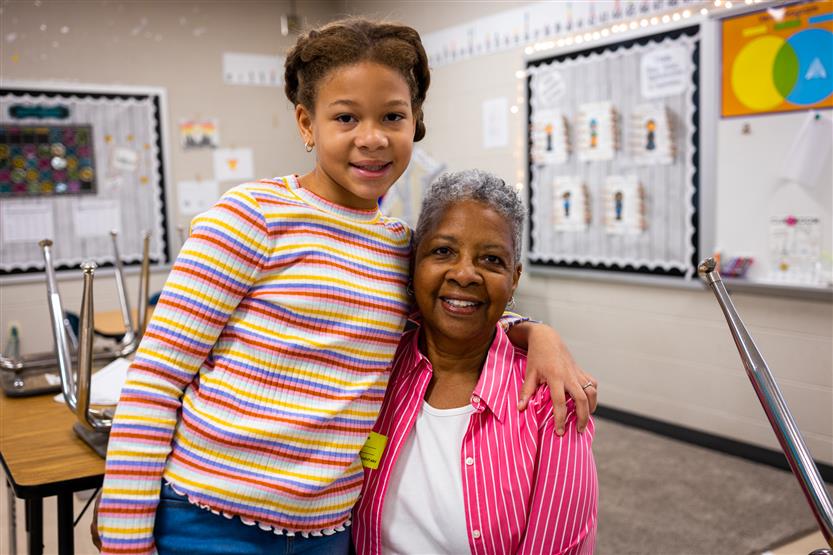 A family smiles at Winstead Elementary's Grandparents Breakfast